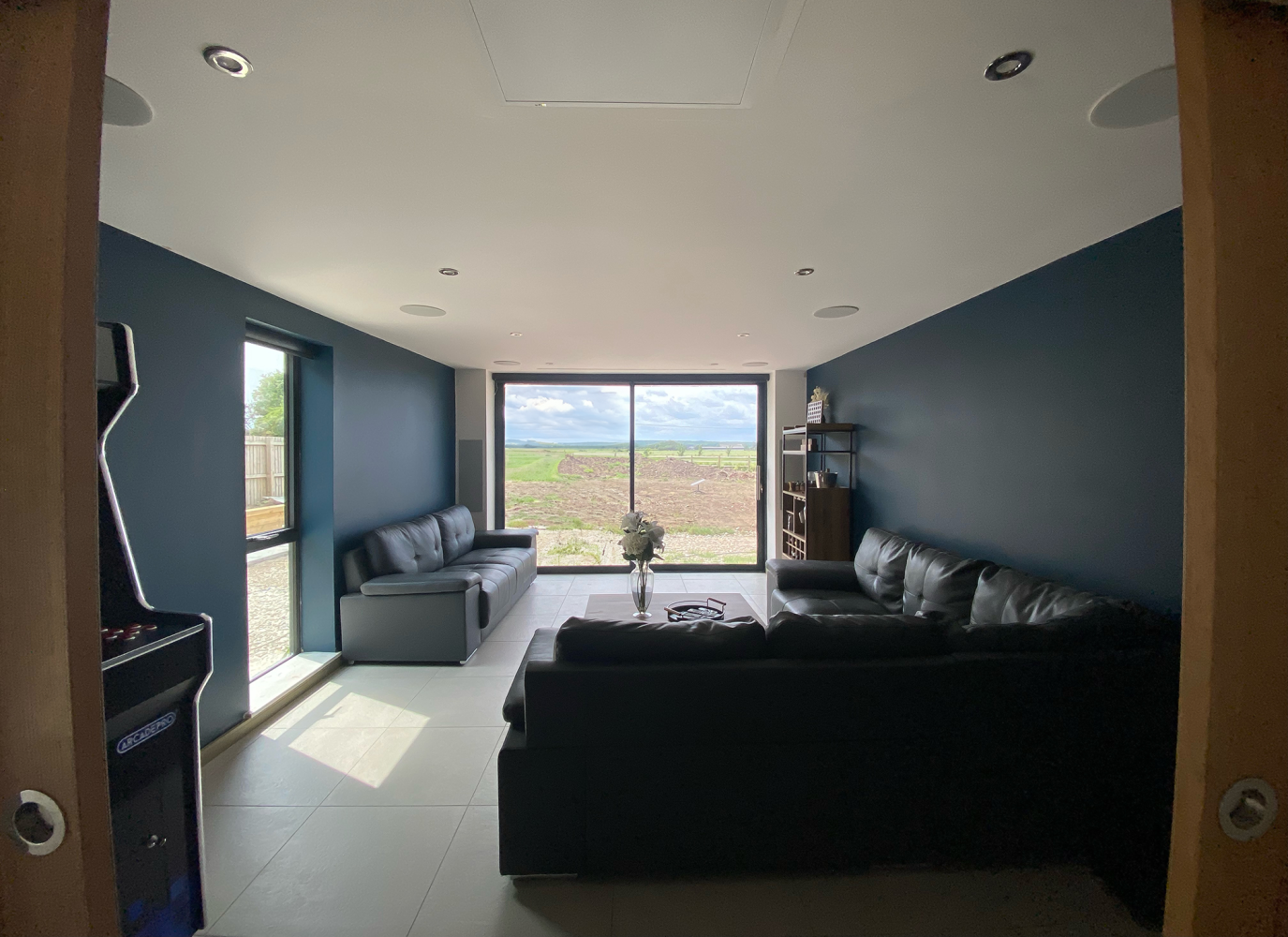 Games room with bifold doors out to countryside view