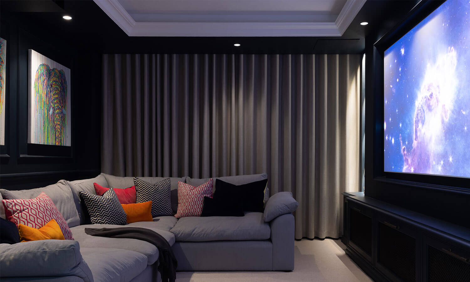 Home Cinema with blue walls and grey sofa