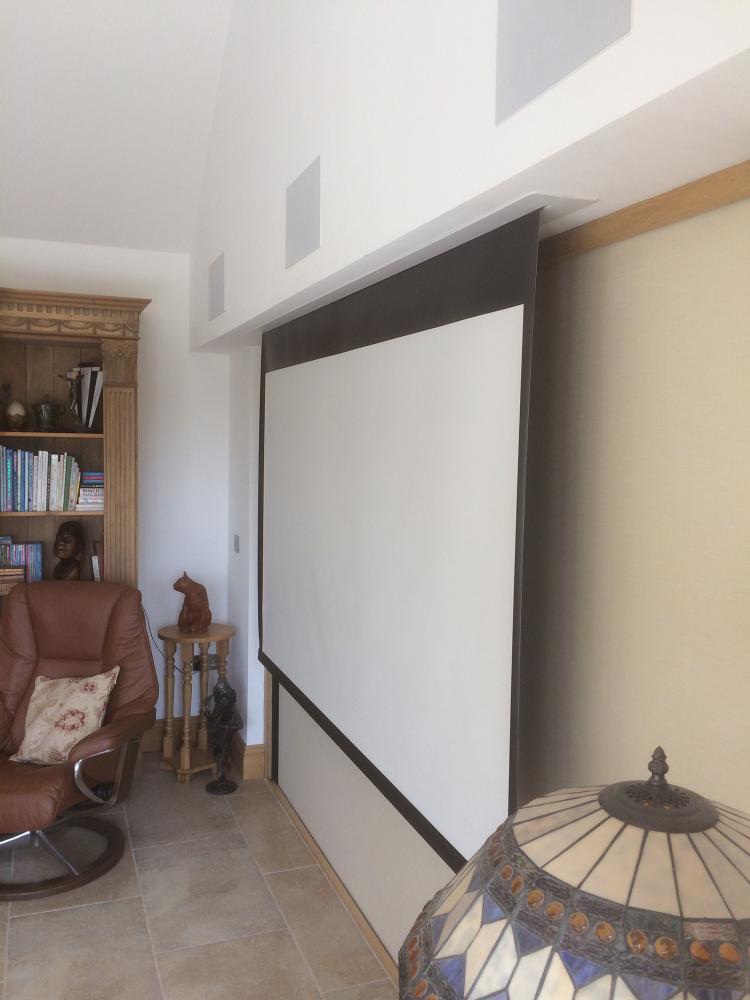 Projector screen in door recesses of bifold doors