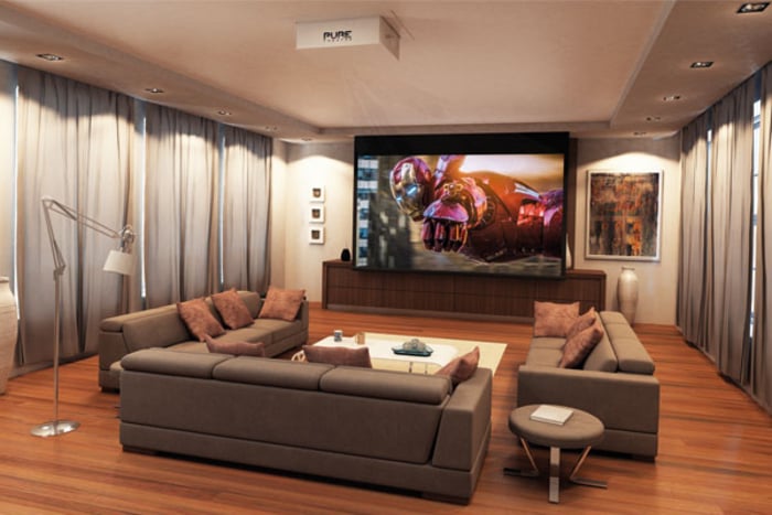 Dedicated Home Cinema with cinema screen and chairs with purple ambient lighting