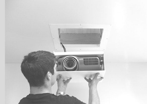 two men tightening screws in projector screen