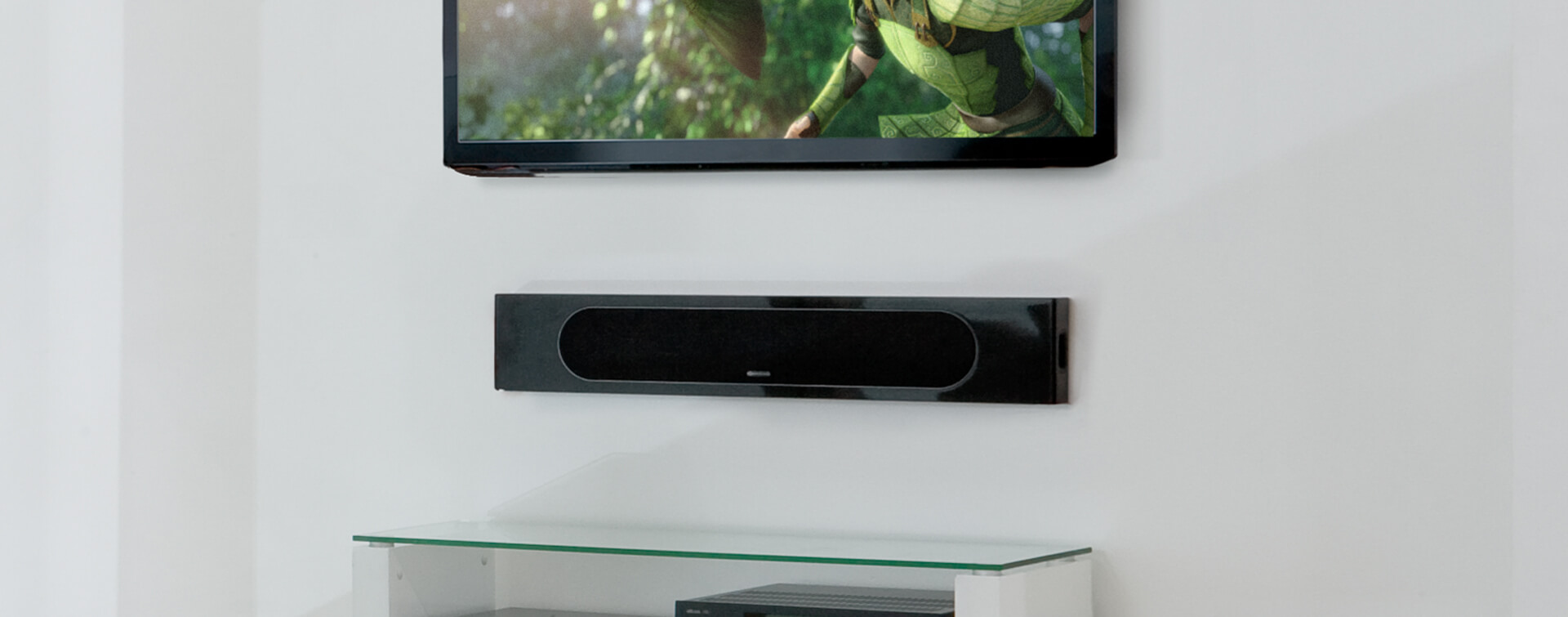 Monitor Audio Radius One in black in a living space beneath tv